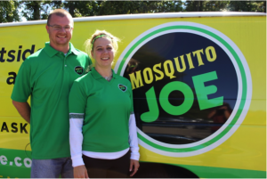 Two Mosquito Joe owners standing in front of a parked Mosquito Joe van
